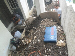 Workers performing pier foundation repair on-site